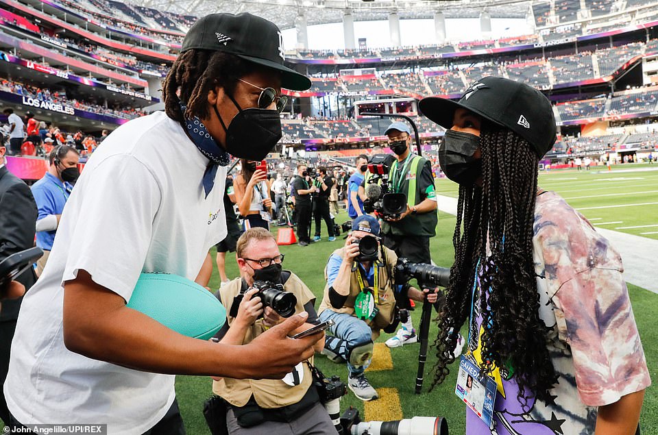 Jay Z is joined by his daughter Blue Ivy on the field at the Super Bowl in Los Angeles