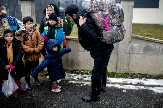 An Afghan family gathers on the streets of Velika Kladusa.