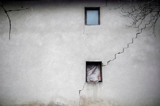 Blankets cover a window to keep the heat inside an abandoned building.