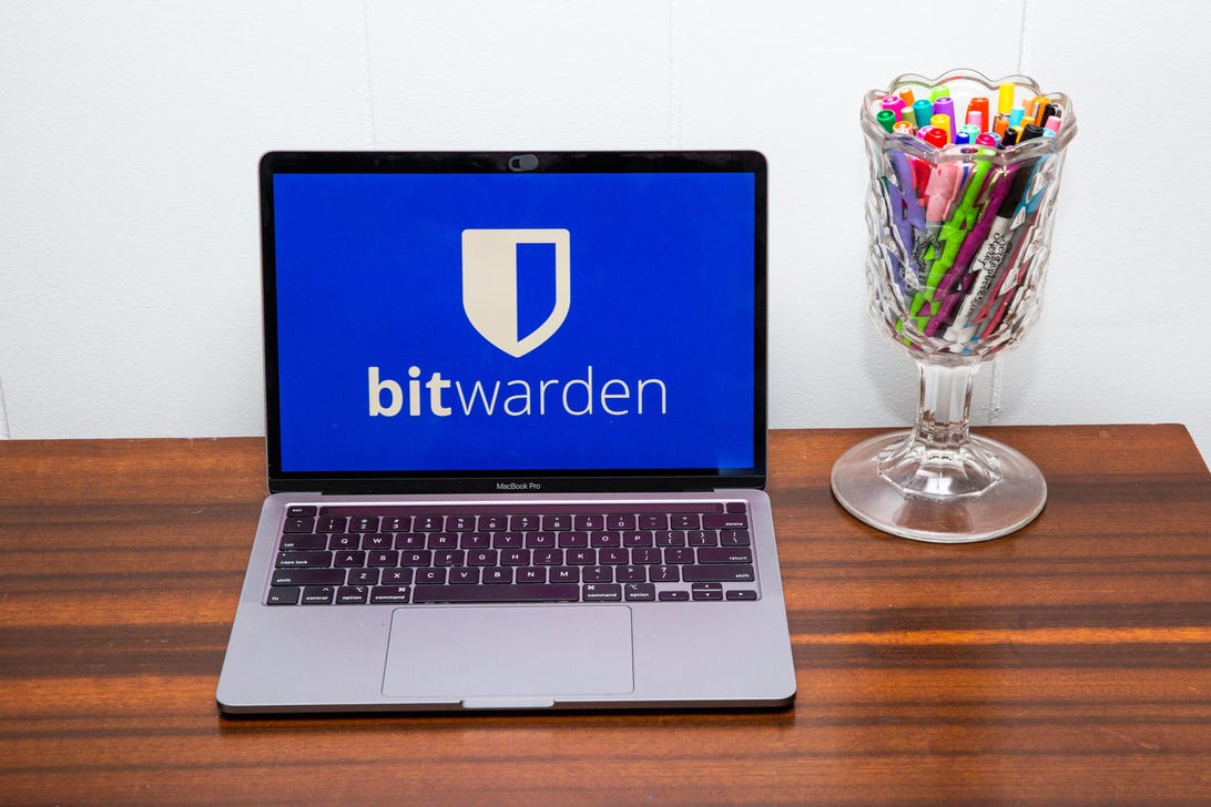 Bitwarden logo on a desk-mounted laptop