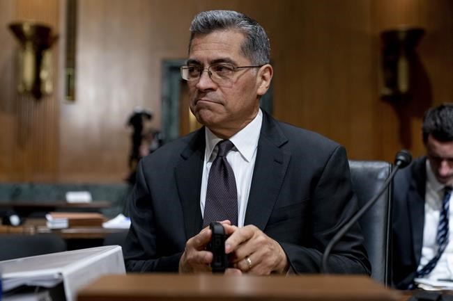 FILE - Health and Human Services Secretary Xavier Becerra arrives for a hearing on Capitol Hill in Washington, April 5, 2022. Medicare recipients will get a premium reduction — but not until next year. That reflects what Becerra says was an overestimate in costs of covering a costly and controversial new Alzheimer's drug. (AP Photo/Andrew Harnik, File)