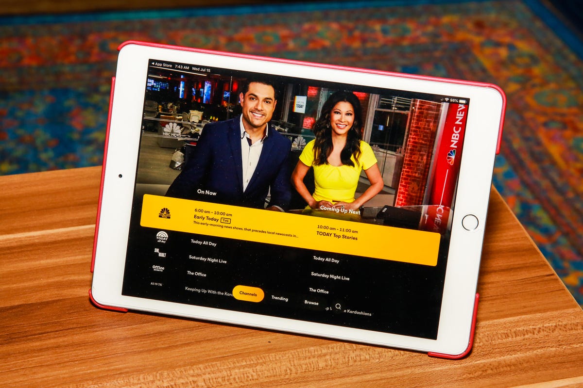 An iPad on a desk displaying the Peacock streaming app