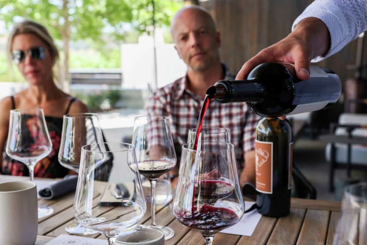 Glasses of Estate Cabernet Franc are poured during a wine tasting at Clos Du Val in Napa, Calif. on Thursday, June 23, 2022. The winery added the new tasting room in 2018 and is among several beloved and citric wineries to undergo rebrands and remodeling.