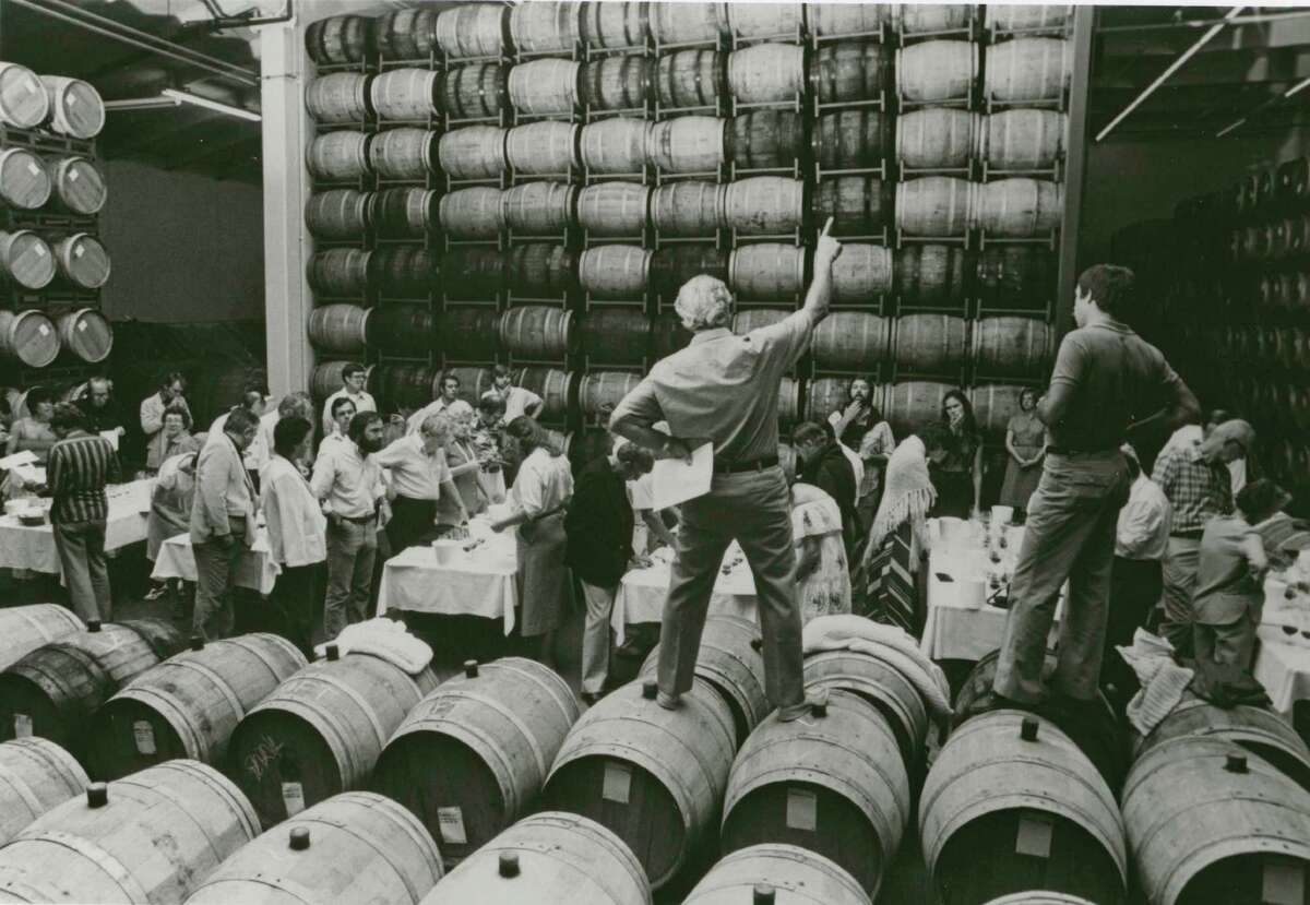 Napa pioneer Robert Mondavi, founder of Robert Mondavi Winery, addresses a group from the barrel room in the late 1970s.
