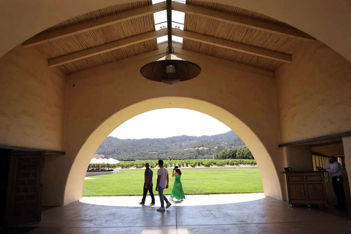 Visitors passing under the iconic arched entryway to Robert Mondavi Winery. A renovation of the winery and visitor center is planned.