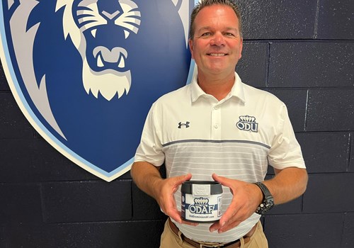 greg smith holding a cup holder