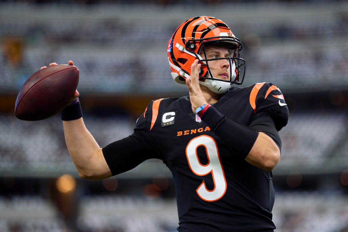 Quarterback Joe Burrow, in Cincinnati Bengals uniform, winds up to throw the ball
